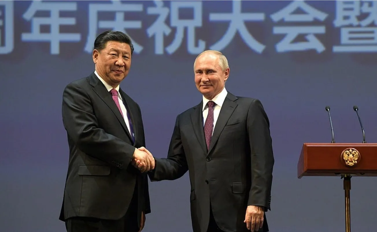 President of China Xi Jinping and President of Russia Vladimir Putin shake hands.